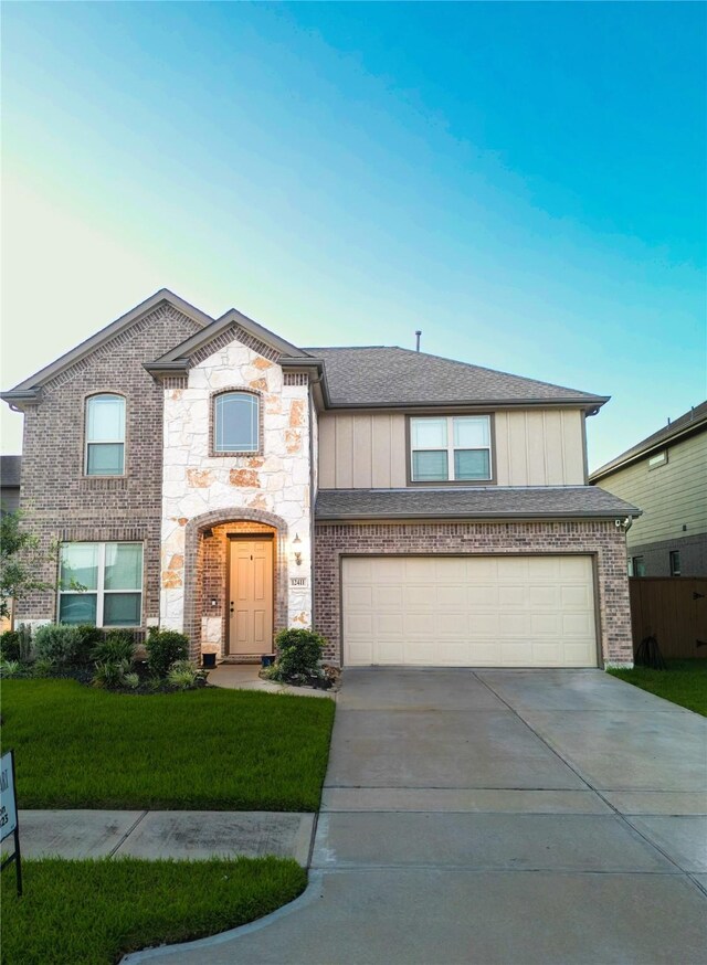 view of front facade with a front yard and a garage