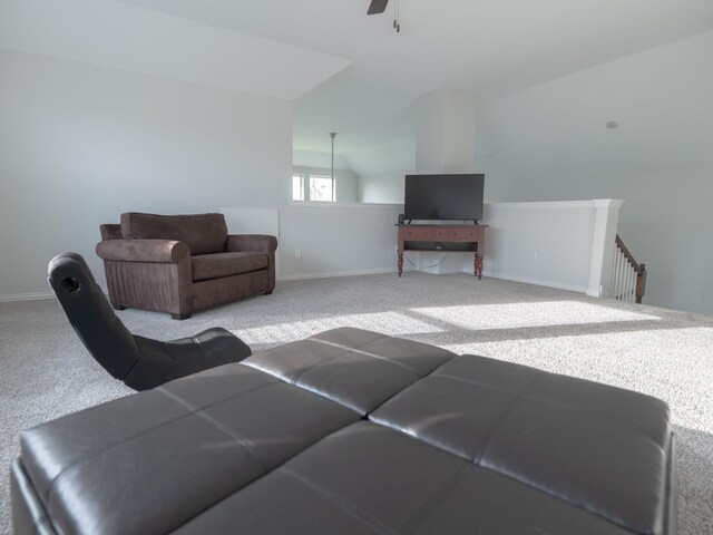 living room featuring lofted ceiling, light colored carpet, and ceiling fan