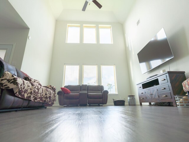 living room featuring a towering ceiling and ceiling fan