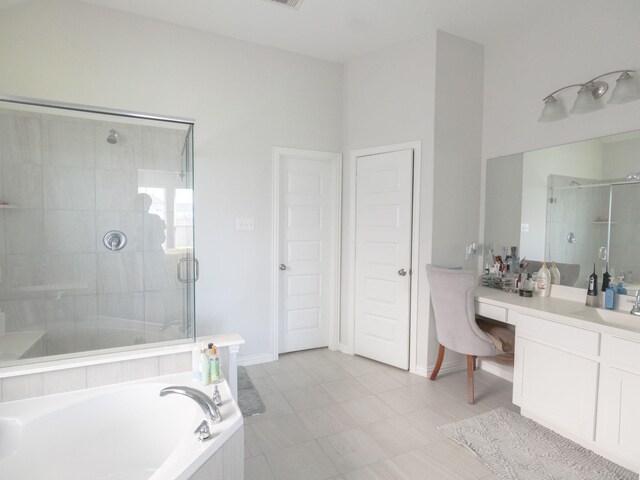 bathroom featuring tile patterned floors, independent shower and bath, and vanity