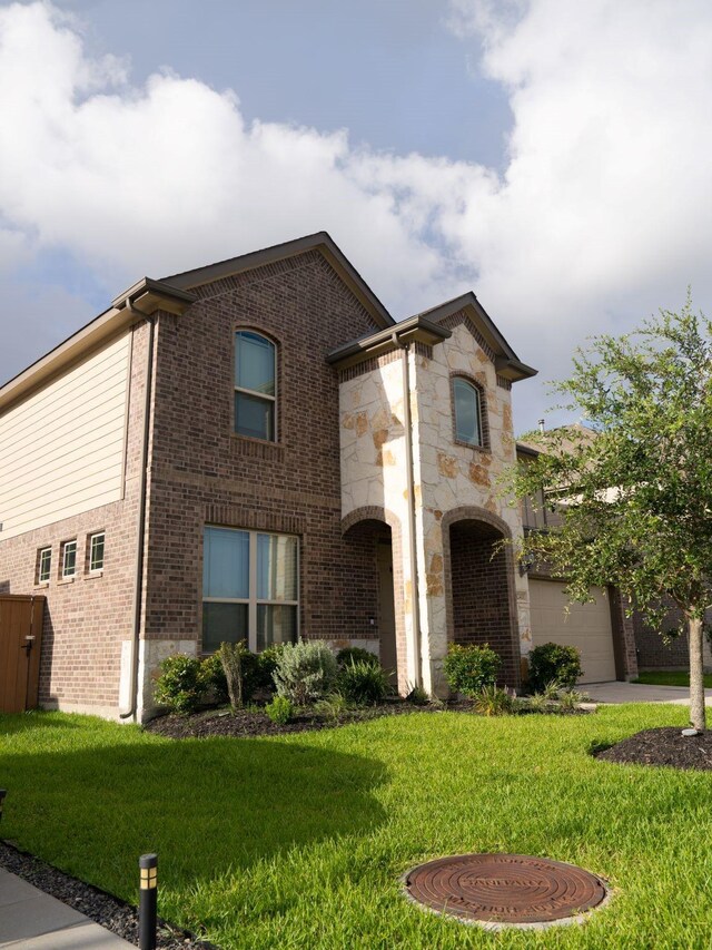 view of front of property with a front lawn and a garage