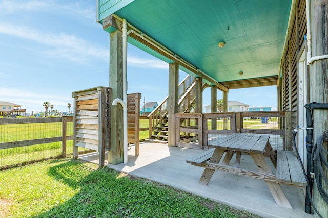 view of patio with a fenced backyard and stairway