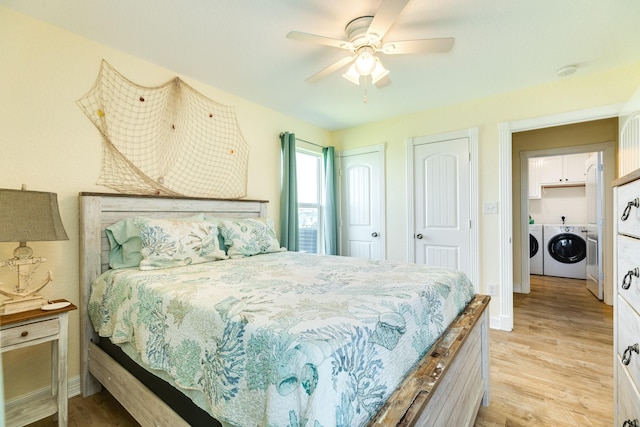 bedroom featuring washer and dryer, ceiling fan, and light hardwood / wood-style flooring