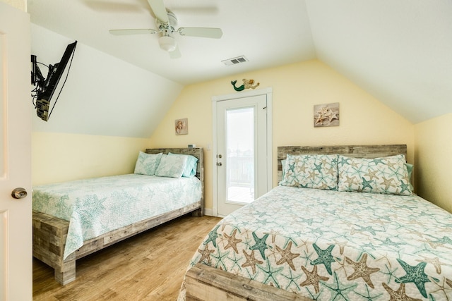 bedroom with vaulted ceiling, wood finished floors, ceiling fan, access to outside, and visible vents