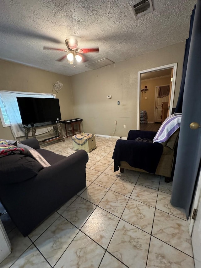 living area featuring a textured ceiling, visible vents, and a ceiling fan