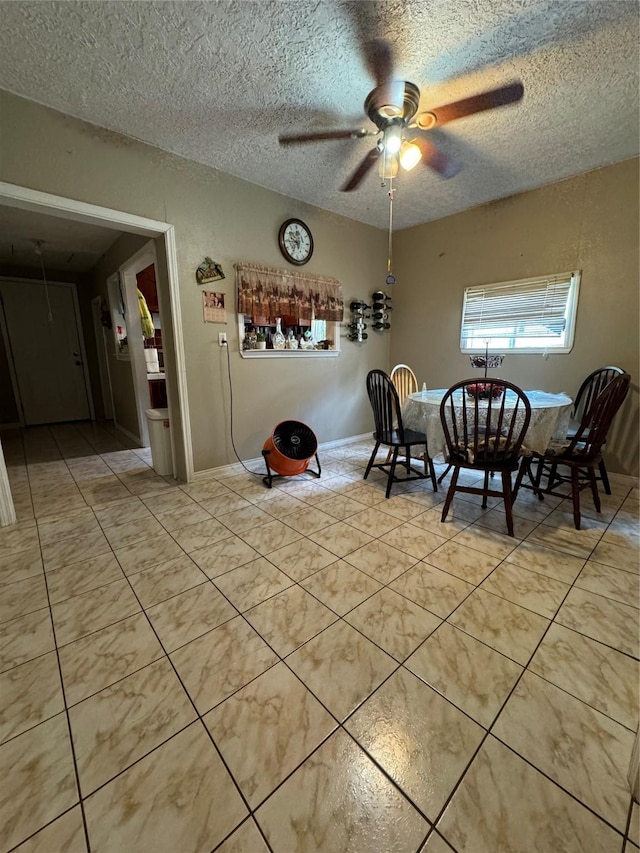 dining room featuring light tile patterned flooring, ceiling fan, and a textured ceiling