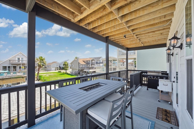 wooden deck featuring a grill