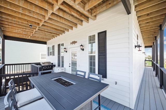 deck featuring a grill and an outdoor fire pit