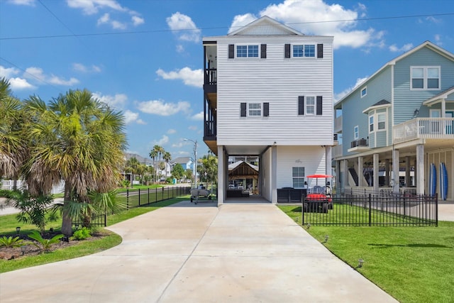 view of front facade with a front yard and a carport