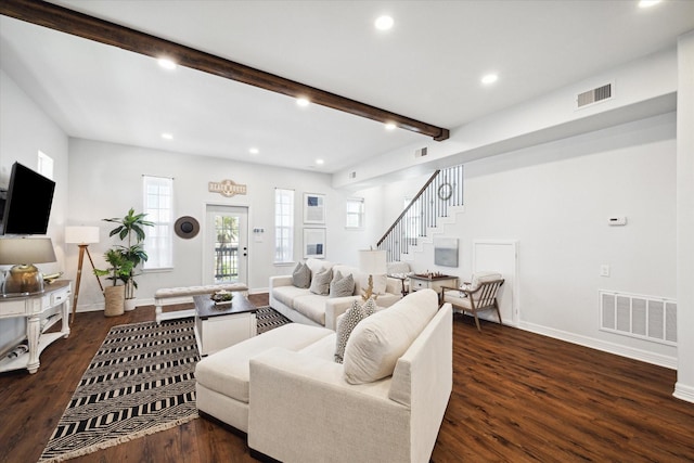 living room featuring beamed ceiling and dark wood-type flooring