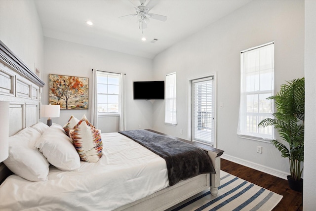 bedroom featuring ceiling fan, dark hardwood / wood-style flooring, access to exterior, and vaulted ceiling