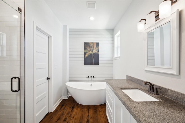 bathroom with separate shower and tub, vanity, and wood-type flooring