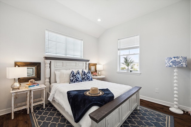 bedroom featuring multiple windows, dark wood-type flooring, and vaulted ceiling