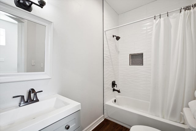 full bathroom with hardwood / wood-style flooring, vanity, toilet, and shower / bath combo with shower curtain