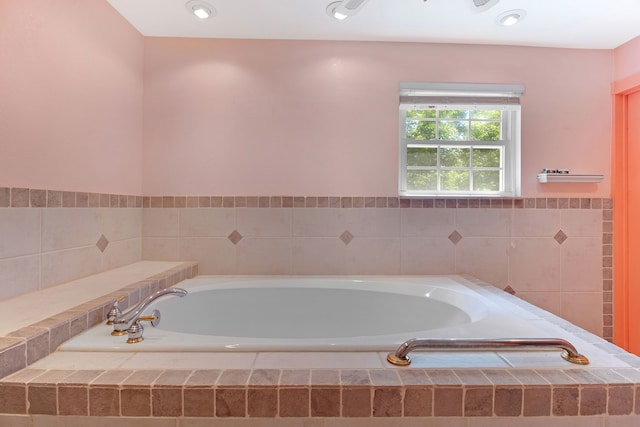 bathroom with a relaxing tiled tub