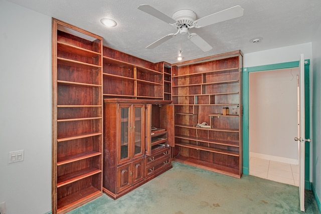 interior space featuring carpet flooring and ceiling fan