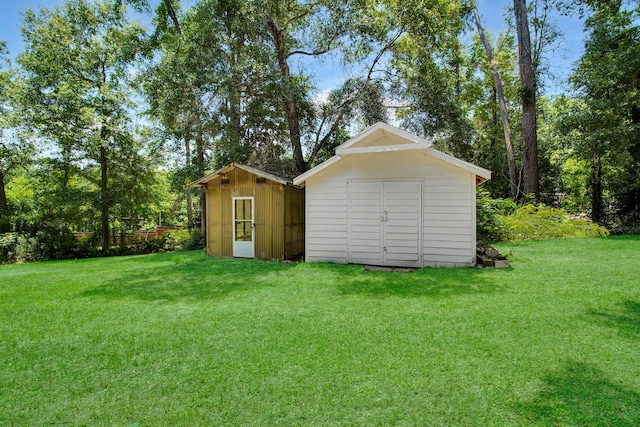 view of outbuilding with a yard