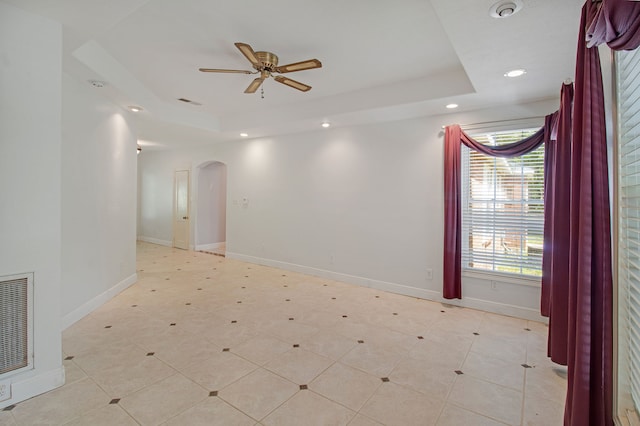 unfurnished room with a tray ceiling and ceiling fan