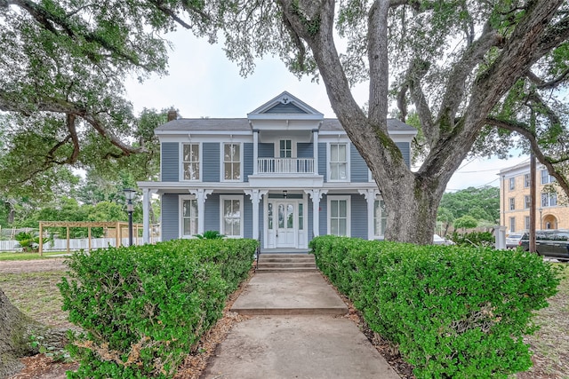 view of front of property featuring covered porch and a balcony