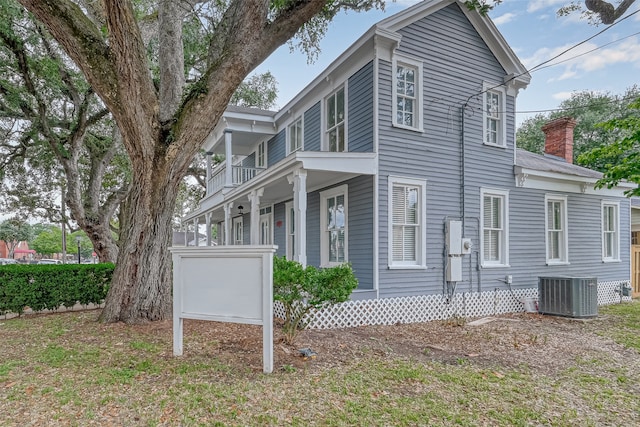 back of house with a balcony and central AC unit