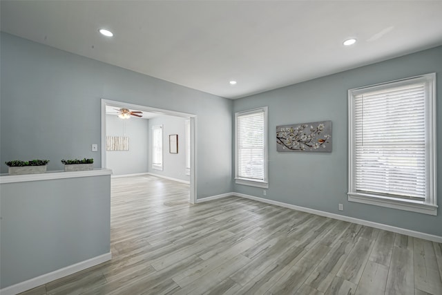 unfurnished living room featuring a wealth of natural light and light hardwood / wood-style flooring