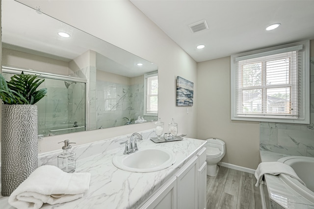 bathroom featuring tile walls, hardwood / wood-style flooring, toilet, and vanity