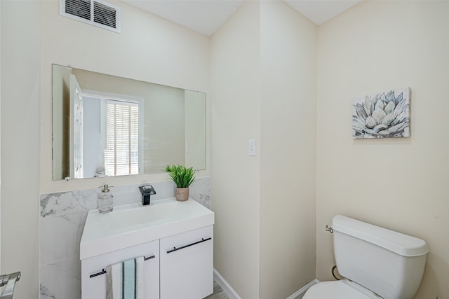 bathroom with toilet and vanity