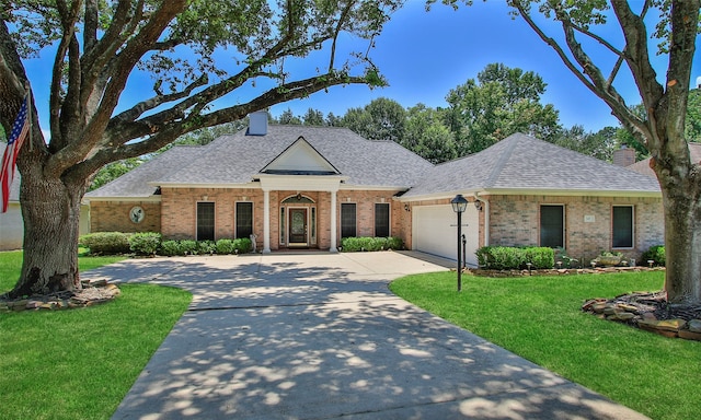 ranch-style home with a garage and a front lawn