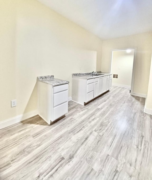 interior space featuring sink and light wood-type flooring