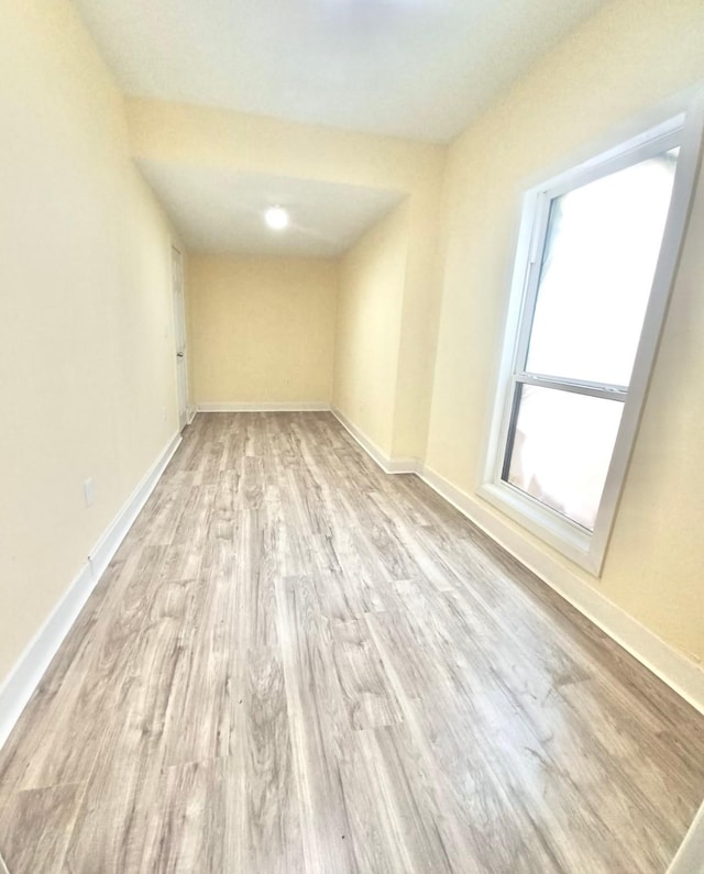 unfurnished room with light wood-type flooring