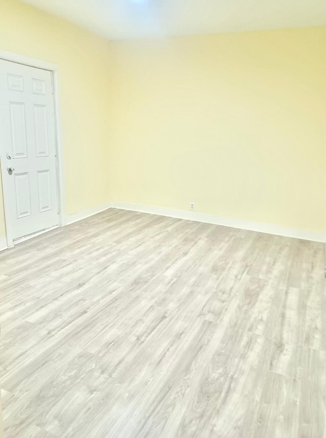 empty room with light hardwood / wood-style flooring