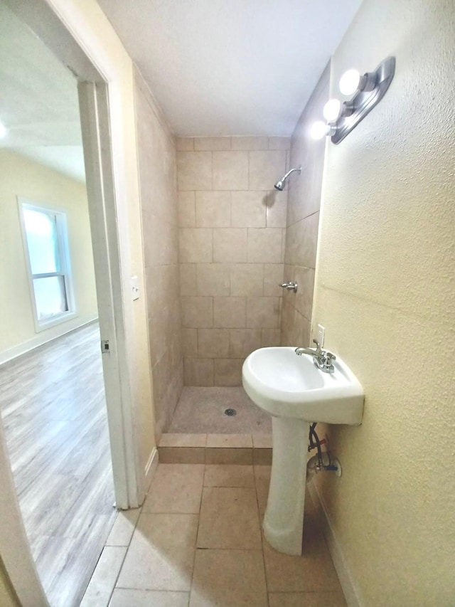 bathroom featuring a tile shower and tile patterned floors