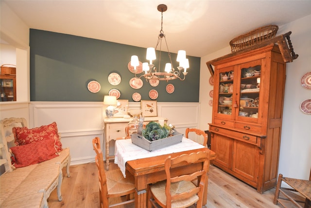 dining area featuring an inviting chandelier and light hardwood / wood-style flooring