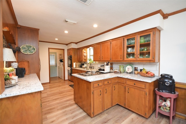 kitchen with light hardwood / wood-style flooring, tasteful backsplash, sink, crown molding, and double oven