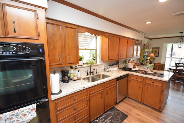 kitchen featuring backsplash, sink, light wood-type flooring, appliances with stainless steel finishes, and kitchen peninsula