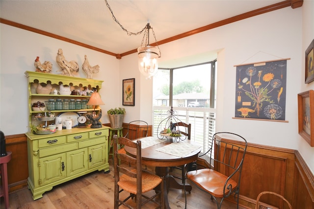 dining room with light hardwood / wood-style floors and ornamental molding