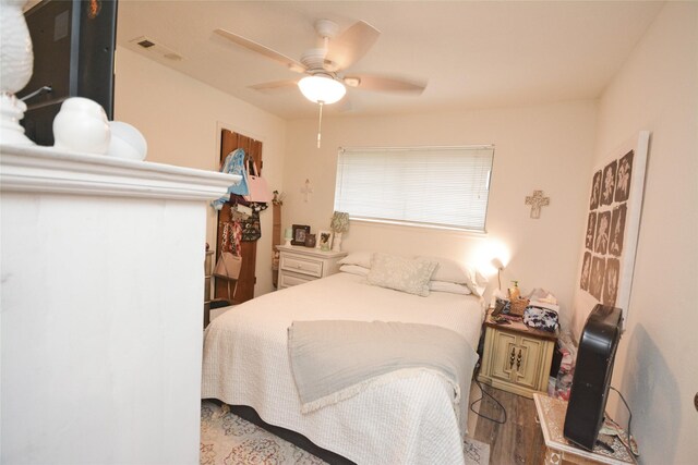 bedroom with ceiling fan and hardwood / wood-style floors