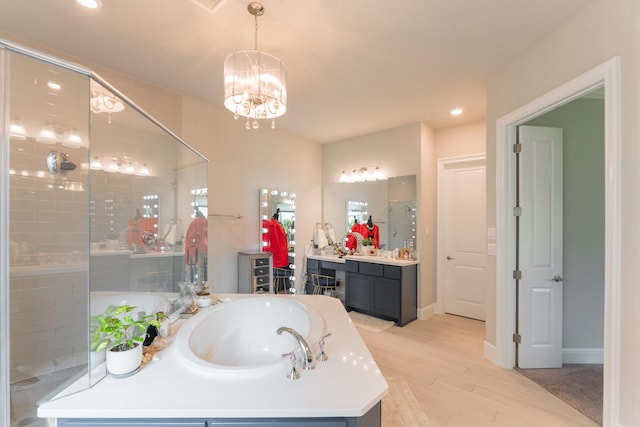 bathroom with separate shower and tub, hardwood / wood-style floors, vanity, and a notable chandelier