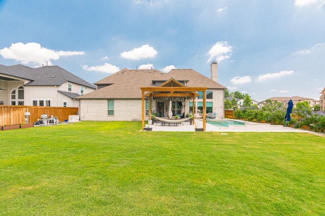 back of house with a patio area, a yard, and a pool with hot tub