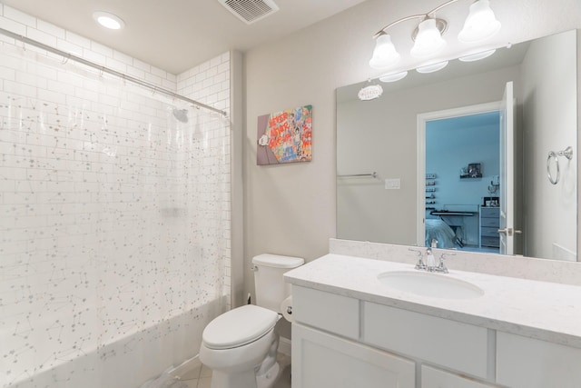 full bathroom with tile patterned floors, tiled shower / bath combo, toilet, and vanity