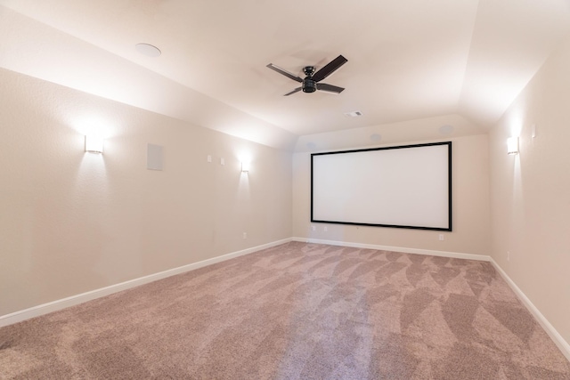 carpeted home theater room featuring ceiling fan and lofted ceiling