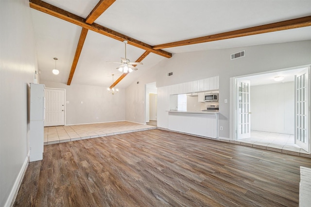 unfurnished living room featuring vaulted ceiling with beams, ceiling fan, and hardwood / wood-style flooring