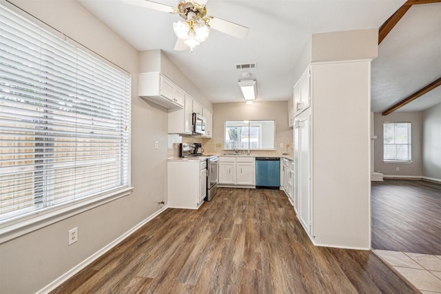 kitchen with appliances with stainless steel finishes, ceiling fan, sink, white cabinets, and dark hardwood / wood-style floors