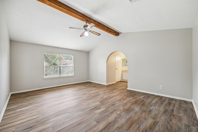 spare room featuring lofted ceiling with beams, ceiling fan, and dark wood-type flooring