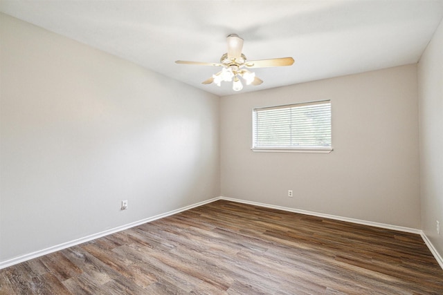 spare room with ceiling fan and dark hardwood / wood-style flooring