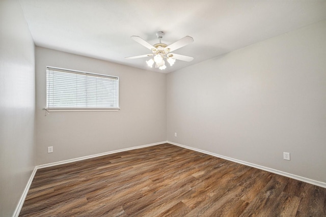 spare room featuring ceiling fan and dark hardwood / wood-style flooring