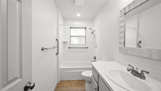 full bathroom featuring vanity, tiled shower / bath, wood-type flooring, and toilet