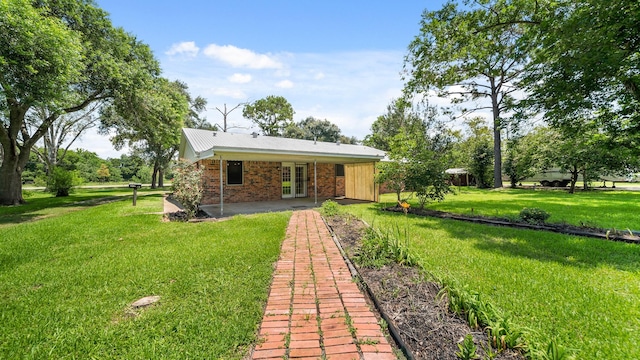 back of property featuring french doors, a patio, and a lawn