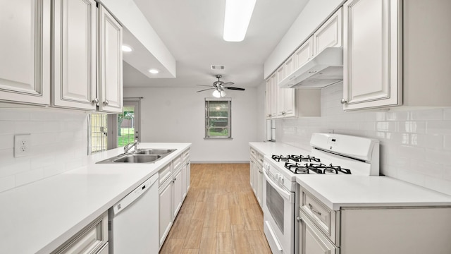 kitchen with light wood-type flooring, white appliances, ceiling fan, sink, and range hood