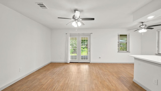 spare room with light wood-type flooring and ceiling fan